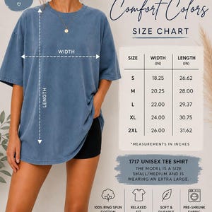 May include: An oversized blue t-shirt with a size chart displaying width and length in inches. The chart lists sizes S through 2XL with corresponding measurements. Text includes Comfort Colors, 1717 Unisex Tee Shirt, and fabric details.