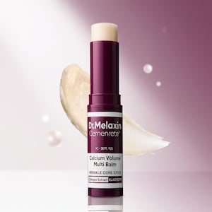 May include: A close-up of a purple and white Dr. Melaxin Cemenrete Calcium Volume Multi Balm stick. The product is a wrinkle core stick with collagen extract. A smear of the balm is next to the stick.