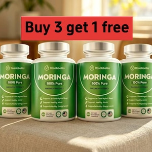 May include: Four green and white supplement bottles of Moringa 100% Pure dietary supplement capsules. The bottles have silver lids and are arranged on a neutral-colored surface. The text "Buy 3 get 1 free" is in a red banner above the bottles.