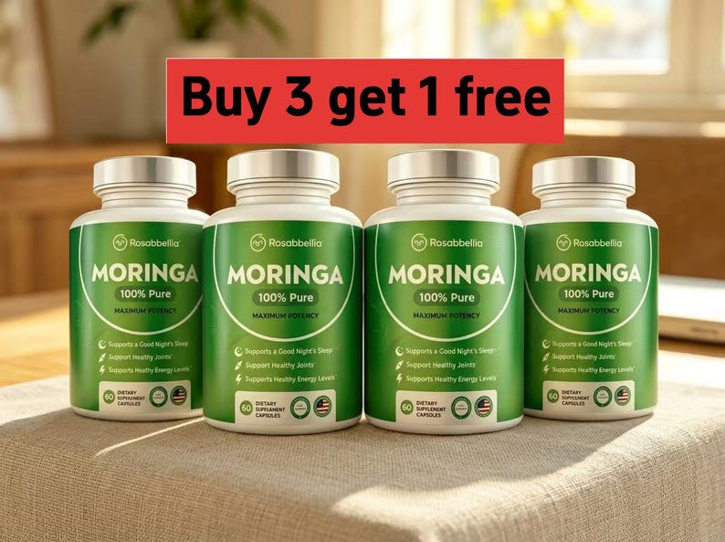 May include: Four green and white supplement bottles of Moringa 100% Pure dietary supplement capsules. The bottles have silver lids and are arranged on a neutral-colored surface. The text "Buy 3 get 1 free" is in a red banner above the bottles.