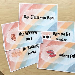 May include: A collection of classroom rule cards with a watercolor background in pastel colors. Each card features a rule: "Our Classroom Rules," "Use listening ears," "No throwing hands," "Eyes on the teacher," and "Walking feet."