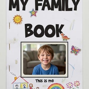 May include: A white paper booklet titled MY FAMILY BOOK in black letters, featuring a central photograph of a smiling child in a blue shirt. The cover is decorated with stickers of a sun, star, dinosaur, and butterfly, plus crayon drawings of a house, family, rainbow, and flowers.