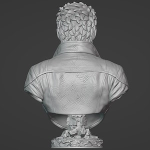 May include: A monochromatic gray bust sculpture of a figure seen from the back. The figure has short, textured hair and wears a jacket with a visible collar and a cross-hatched pattern on the back. The bust rests on a base made of stacked stone.