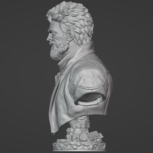 May include: A monochromatic gray bust sculpture depicting a side profile of a bearded individual with textured, layered hair. The figure wears a collared jacket with visible shoulder detailing, resting on a base composed of stacked, irregular stone blocks.