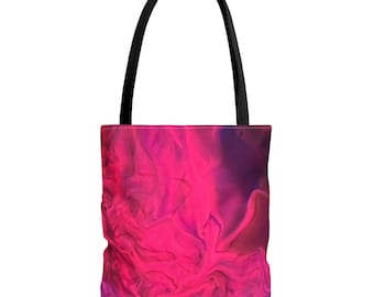 May include: A tote bag with a vibrant abstract design in shades of pink and purple. The bag features a black handle and a colorful, swirling pattern across the front. The design resembles a watercolor or ink-wash effect.