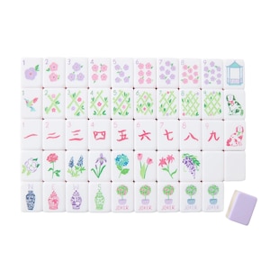 May include: A complete set of white Mahjong tiles with various floral and geometric designs in pastel colors. The set includes tiles with numbers, Chinese characters, and joker tiles. A single lavender tile is also included.