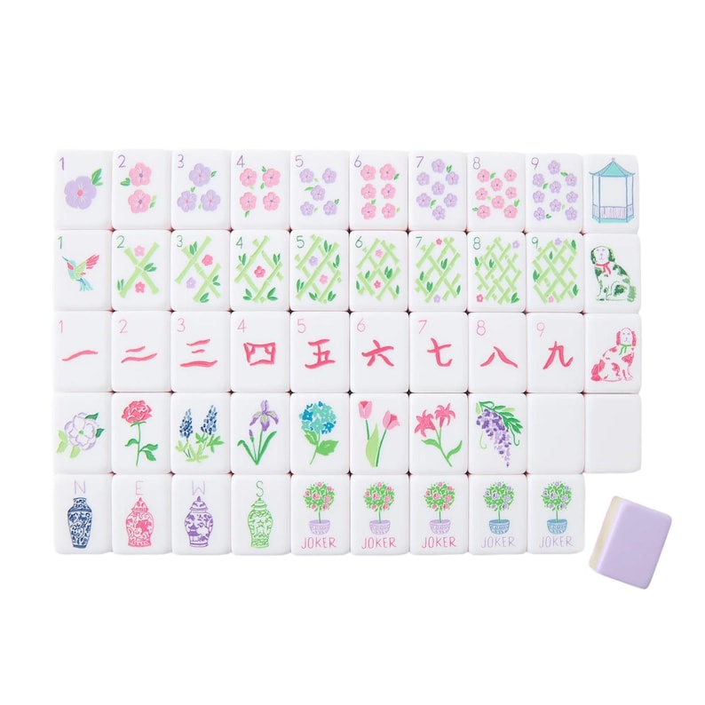 May include: A complete set of white Mahjong tiles with various floral and geometric designs in pastel colors. The set includes tiles with numbers, Chinese characters, and joker tiles. A single lavender tile is also included.