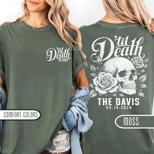 May include: A moss green t-shirt featuring a small white graphic on the front left chest that reads 'til Death THE DAVIS 05.19.2026. The back displays a large white illustration of a human skull surrounded by roses with the text 'til Death THE DAVIS 05.19.2026.