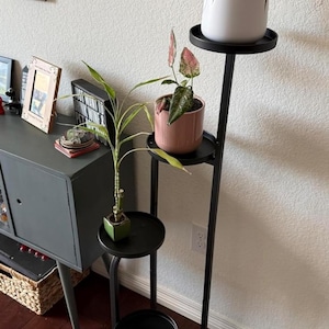 May include: A rustic wooden sign with the text "Welcome to our home" in white lettering. The sign features a distressed finish and a simple, inviting design, perfect for entryway decor.