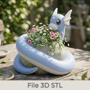 May include: A light blue and white decorative planter shaped like a cartoon dragon, filled with pink and white flowers and greenery. The planter is sitting on a wooden table. The text "File 3D STL" is at the bottom of the image.