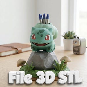 May include: A green Bulbasaur-shaped pen holder with red eyes and a smiling expression. The pen holder is on a gray rock base with grass and mushroom accents. The text "File 3D STL" is at the bottom. Three blue pens are in the holder.