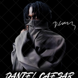 May include: A portrait of Daniel Caesar featuring the artist with braided hair, partially obscuring their face with a dark grey collared garment. The image includes the handwritten signature D. Caesar and the printed text DANIEL CAESAR below.