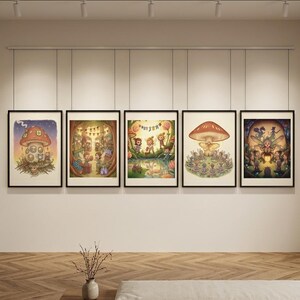 May include: Five framed rectangular wall art prints featuring colourful illustrations of fantasy characters, mushrooms, and woodland scenes. Each print is displayed in a thin black frame, arranged in a horizontal row on a plain wall.