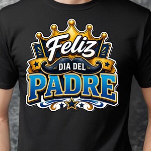 May include: Black t-shirt with a colorful graphic design. The design features the words "Feliz Dia Del Padre" in white and blue, a gold crown, and a stylized mustache. The shirt is made of a soft material.