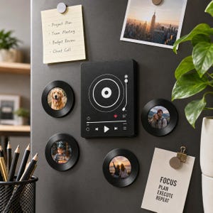 May include: A rectangular black music player magnet featuring a white vinyl record graphic and playback controls, surrounded by four circular black vinyl record magnets displaying various photographs, all attached to a dark grey magnetic surface.