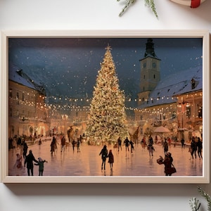 May include: A rectangular framed print featuring a winter town square at night with a large illuminated Christmas tree, people ice skating, and a clock tower. The frame is light wood, surrounded by pine branches, red ribbons, and ornaments.