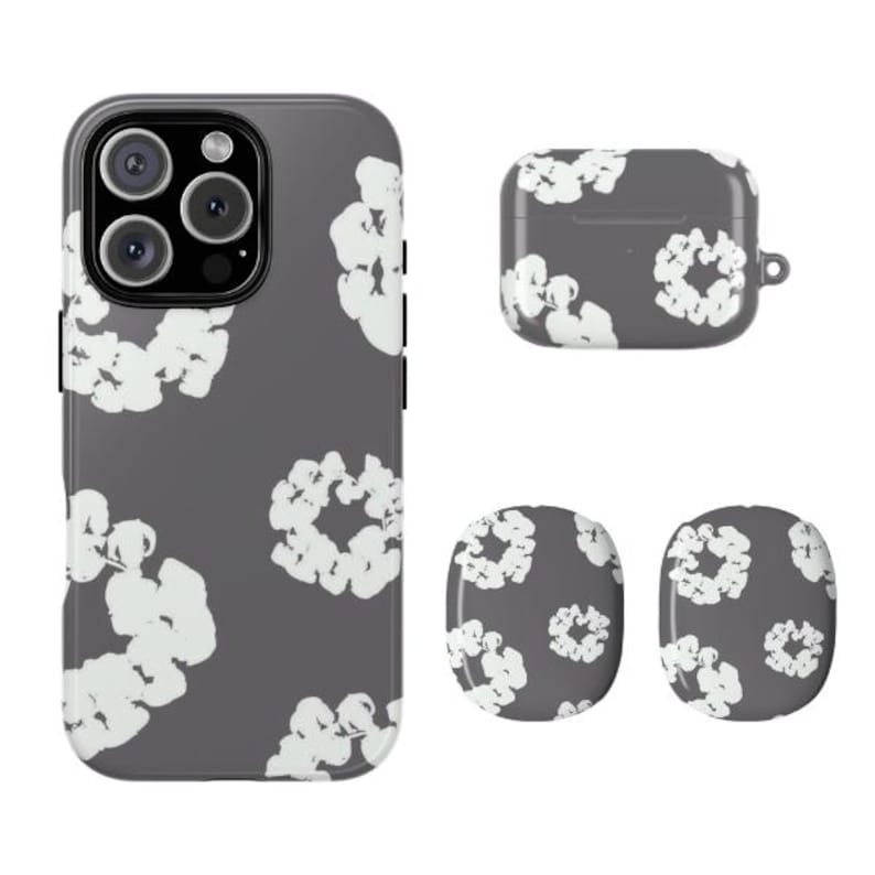 May include: A set of matching phone accessories in a dark gray color, featuring a white floral pattern. The set includes a phone case, an earbud case, and two round pop sockets.