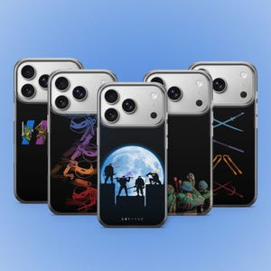 May include: A collection of five phone cases with black backgrounds and various Teenage Mutant Ninja Turtles designs. Each case features a different graphic, including the turtles, weapons, and a full moon scene. The cases have silver edges and are displayed against a blue backdrop.