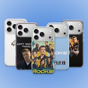 May include: A selection of phone cases with different designs. One case is white with a vehicle graphic, another has the text "DON'T TOUCH PHONE!" and a portrait. Other cases display cast photos and the title "THE ROOKIE" with the text "NEVER OFF DUTY".