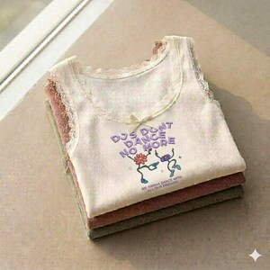 May include: Three corduroy tank tops in cream, mauve, and olive green are stacked. The top tank has cream lace trim, a small bow, and the text "DJs Don't Dance No More" with dancing flower graphics.