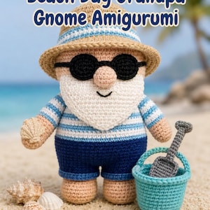May include: A crocheted gnome amigurumi wearing a tan sun hat, black sunglasses, and a blue and white striped shirt with dark blue shorts. The gnome has a white beard, holds a seashell, and stands next to a light blue bucket with a gray shovel.