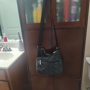 Bolso pequeño bandolera Baggallini, estampado en peltre y negro, forro rosa, nuevo.