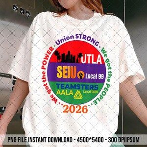 May include: White t-shirt with a circular graphic featuring the text "Union Strong" and "We got the power, we got the people." The graphic includes a cityscape silhouette, the text "SEIU Local 99," and "Teamsters AALA Local 2010." The year "2026" is also displayed.