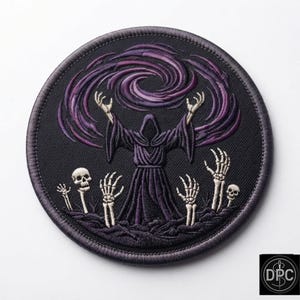 May include: A circular embroidered patch featuring a dark robed figure with arms raised toward a swirling purple vortex. Below the figure, several skeletal hands and two skulls emerge from the ground, all rendered in shades of black and purple.
