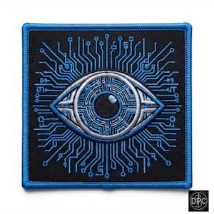 May include: A square embroidered patch featuring a central eye design composed of blue and silver circuit board patterns on a black background. The eye is surrounded by radiating blue lines resembling electronic pathways with a blue stitched border.