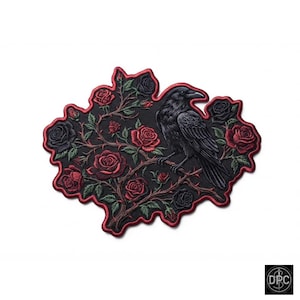 May include: An embroidered patch featuring a black raven perched on a thorny branch surrounded by red and black roses. The design is set against a black background with a red stitched border that follows the irregular shape of the floral arrangement.