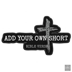 May include: A black embroidered patch featuring the white text ADD YOUR OWN SHORT BIBLE VERSE. The design includes a grey, textured cross graphic integrated into the lettering. The patch has a black stitched border and a distinct, irregular shape.
