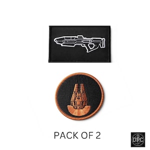 May include: A pack of two embroidered patches. The top patch is rectangular and black with a white outline of a futuristic rifle. The bottom patch is circular with a copper-coloured border, featuring a copper-coloured drop pod on a black background.
