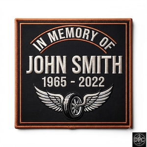 May include: A square black embroidered patch with a copper-coloured border. The text reads IN MEMORY OF JOHN SMITH 1965-2022 in white lettering. Below the text is an embroidered graphic of a black tyre with silver wings extending outwards.