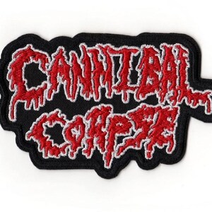 May include: Embroidered patch with the text "CANNIBAL CORPSE" in red, dripping-style lettering. The text is outlined in white and set against a black background. The patch has a black border and is likely for clothing or accessories.