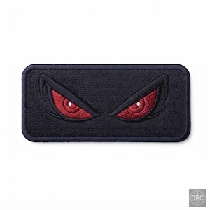 May include: A rectangular embroidered patch featuring a dark navy blue background with a pair of stylised, sharp-angled eyes. The eyes have deep red irises and white pupils, creating a focused, intense expression on the fabric surface.