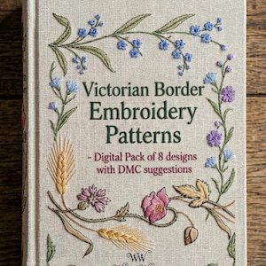 May include: A book titled "Victorian Border Embroidery Patterns" with floral embroidery on the cover. The cover has a cream background with embroidered flowers in blue, pink, and purple. The text reads "Digital Pack of 8 designs with DMC suggestions."