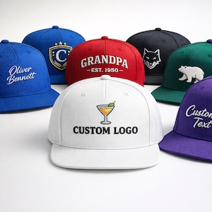 Op de afbeelding: Een verzameling baseballpetten in diverse kleuren, waaronder blauw, rood, wit, zwart, groen en paars. Elke pet heeft geborduurde ontwerpen, logo's of tekst, zoals een cocktailglas, een wolf, een beer en het woord "Grandpa".