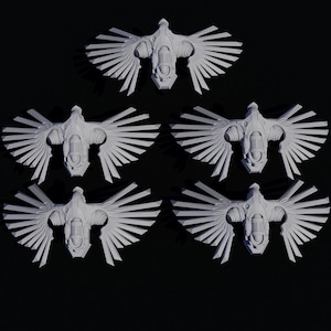 May include: Five white, stylized winged emblems with a mechanical design are arranged against a black background. Each emblem features a central body with detailed wings, suggesting a futuristic or fantasy theme. The emblems are evenly spaced.