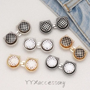 May include: A collection of cat-shaped metal buttons with checkered patterns. The buttons come in silver and gold tones, with the text "YYXaccessory" visible at the bottom.