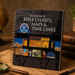 May include: A spiral-bound book titled Rose Book of Bible Charts, Maps & Time Lines with a black cover featuring a blue 10th Anniversary emblem and various historical images. The book is displayed upright on a surface with a map pattern.