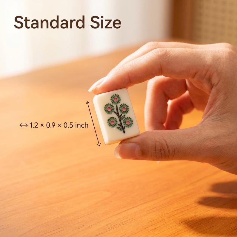 May include: A rectangular off-white mahjong tile featuring a green and pink floral design. The tile is labeled Standard Size and includes dimensions of 1.2 x 0.9 x 0.5 inches, indicating its physical size for game play and collection.