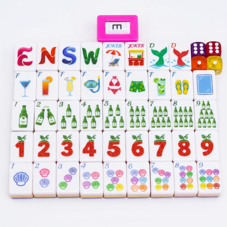 May include: A set of white mahjong tiles arranged in a grid, featuring colorful illustrations of letters, numbers, cocktails, beach items, and seashells. A pink tile holder with the letter E is at the top, alongside four translucent dice.