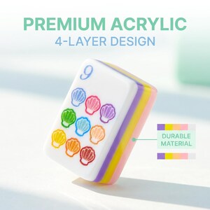 May include: A white acrylic mahjong tile featuring the number 9 and nine colorful seashell icons in blue, pink, purple, green, light blue, orange, yellow, and red. The tile has a 4-layer design with purple, yellow, and pink side stripes.
