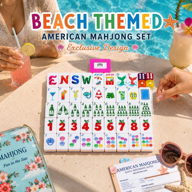 May include: A beach-themed American Mahjong set featuring white tiles with colorful illustrations of drinks, beach gear, and numbers. The set includes a pink tile rack, a floral storage case, and a quick reference guide on a sandy surface.