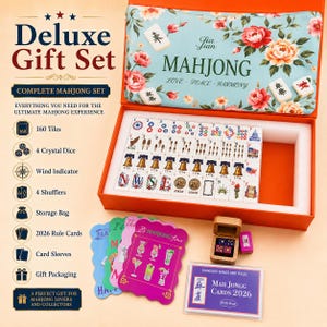 May include: A deluxe mahjong gift set in an orange box with a floral lid. The set includes 160 tiles featuring American-themed icons like bells and eagles, four crystal dice in a wooden box, 2026 rule cards, card sleeves, and a storage bag.