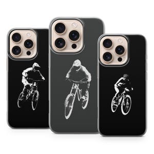 May include: Black and clear phone cases with a white silhouette of a mountain biker. The cases feature a design of a cyclist riding a mountain bike. The cases are designed for a smartphone.