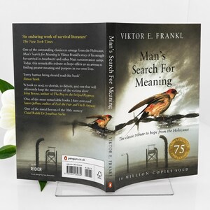 May include: A book titled "Man's Search For Meaning" by Viktor E. Frankl. The cover features a bird perched on a wire, with the title in large, bold letters. The book is a tribute to hope from the Holocaust.