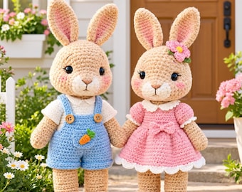 May include: Two crocheted beige rabbits standing side by side. The left rabbit wears blue overalls with a small orange carrot detail and a white shirt. The right rabbit wears a pink dress with a white collar, a bow, and a small pink flower.