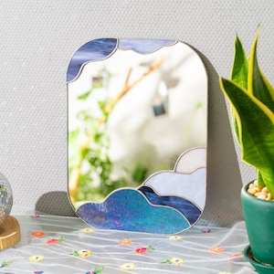 Stained glass cloud mirror on table with plant decor and soft natural light