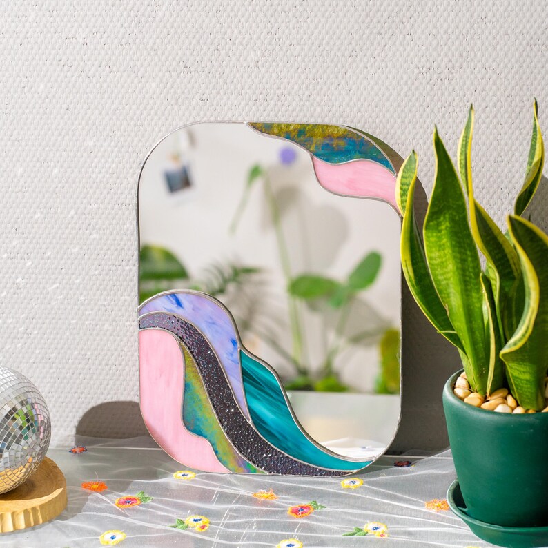 Stained glass mirror close up colorful glass waves texture pink green blue handmade decor detail